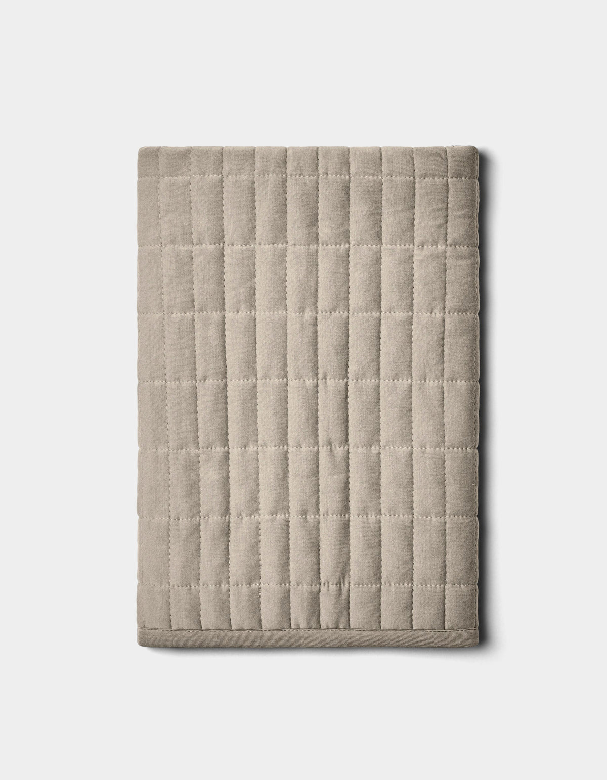 The Bamboo Jersey Quilted Shams by Cozy Earth, shown neatly folded in beige with a grid pattern, are displayed on a plain light background.|Color:Driftwood