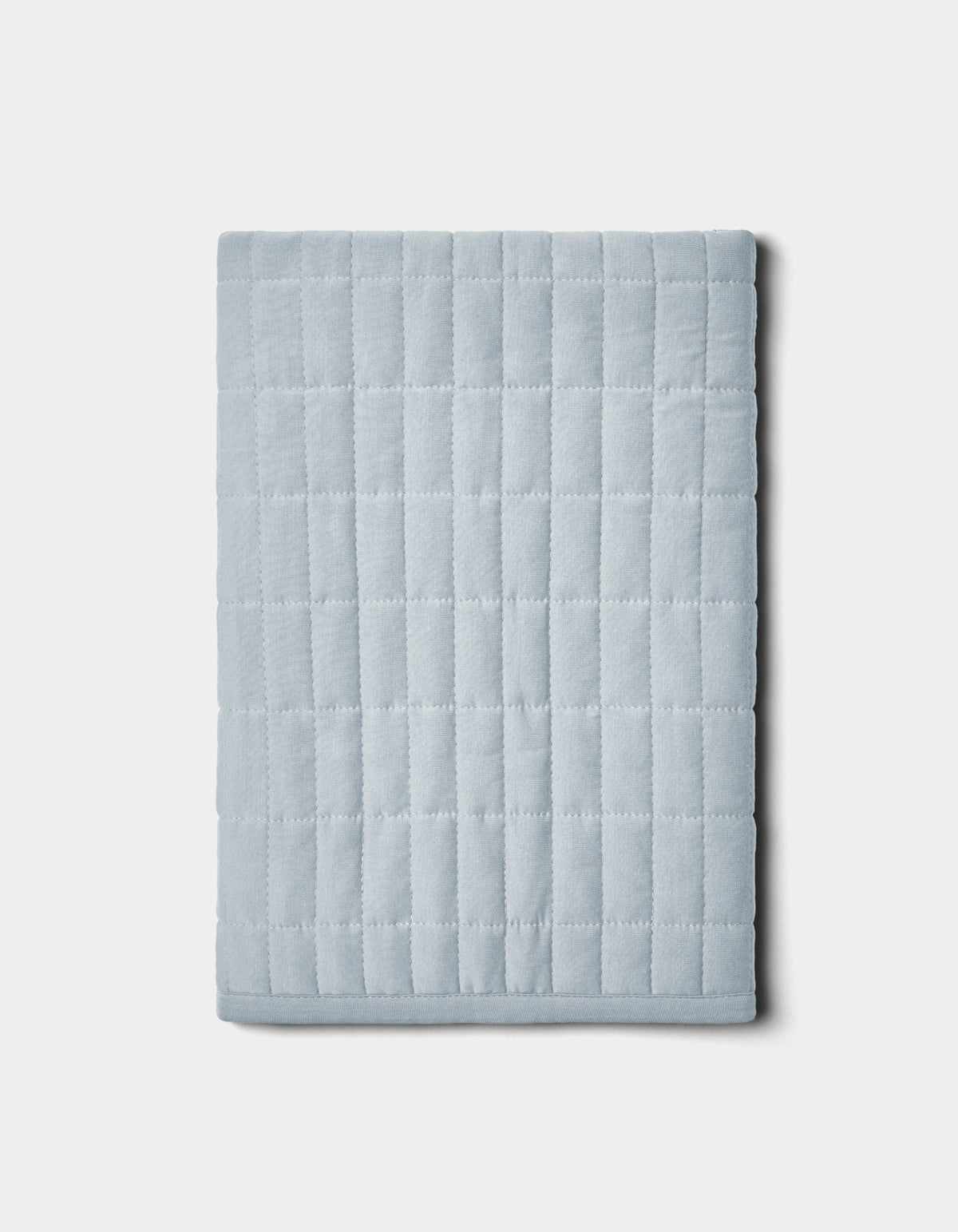 The Cozy Earth Bamboo Jersey Quilted Shams feature a folded, light gray design with a square grid pattern, shown on a plain white background.|Color:Shore