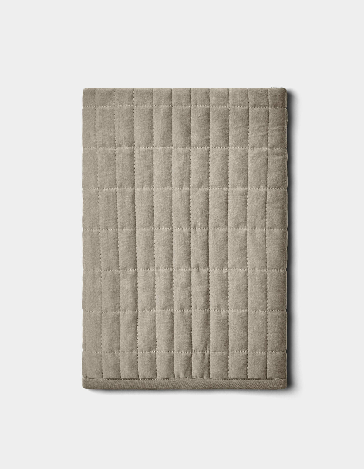 The Cozy Earth Bamboo Jersey Quilted Shams in beige feature a square grid pattern and are displayed folded on a plain white background.|Color:Stone