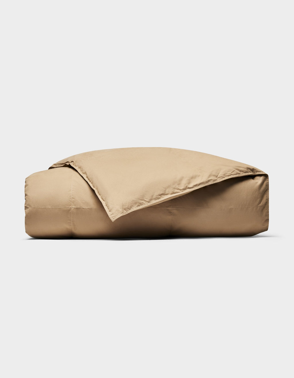 The Cozy Earth Down Alternative Throw, in tan, is neatly folded with one corner draped open against a plain white background.|Color:Sandalwood