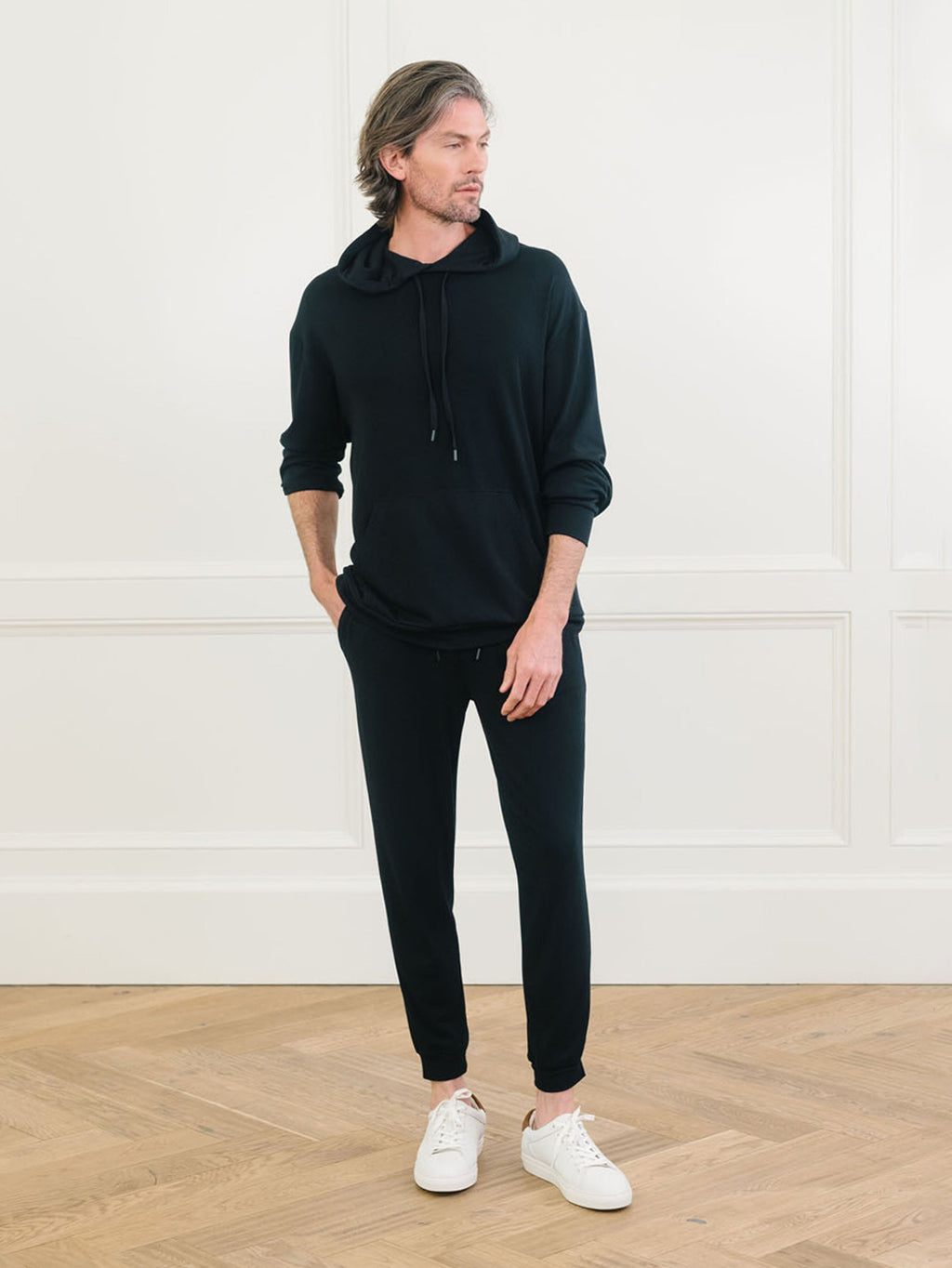 A man wears Men's Brushed Bamboo Hoodie & Jogger Set in Black. |Color:Black