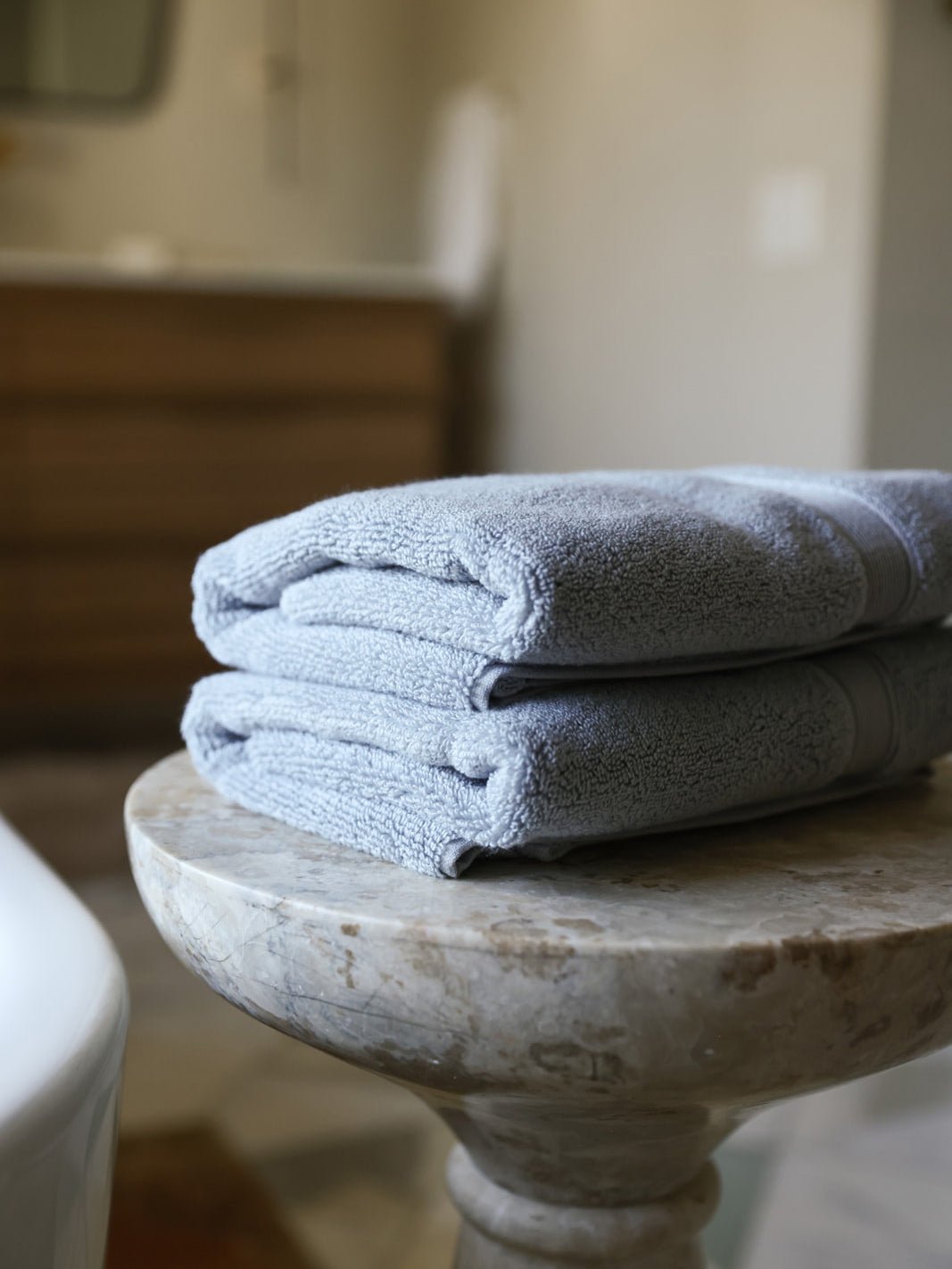 Harbor mist luxe hand towels folded on small table |Color:Harbor Mist