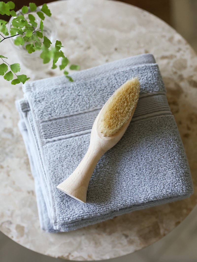 Harbor mist washcloths folded on small table with brush |Color:Harbor Mist