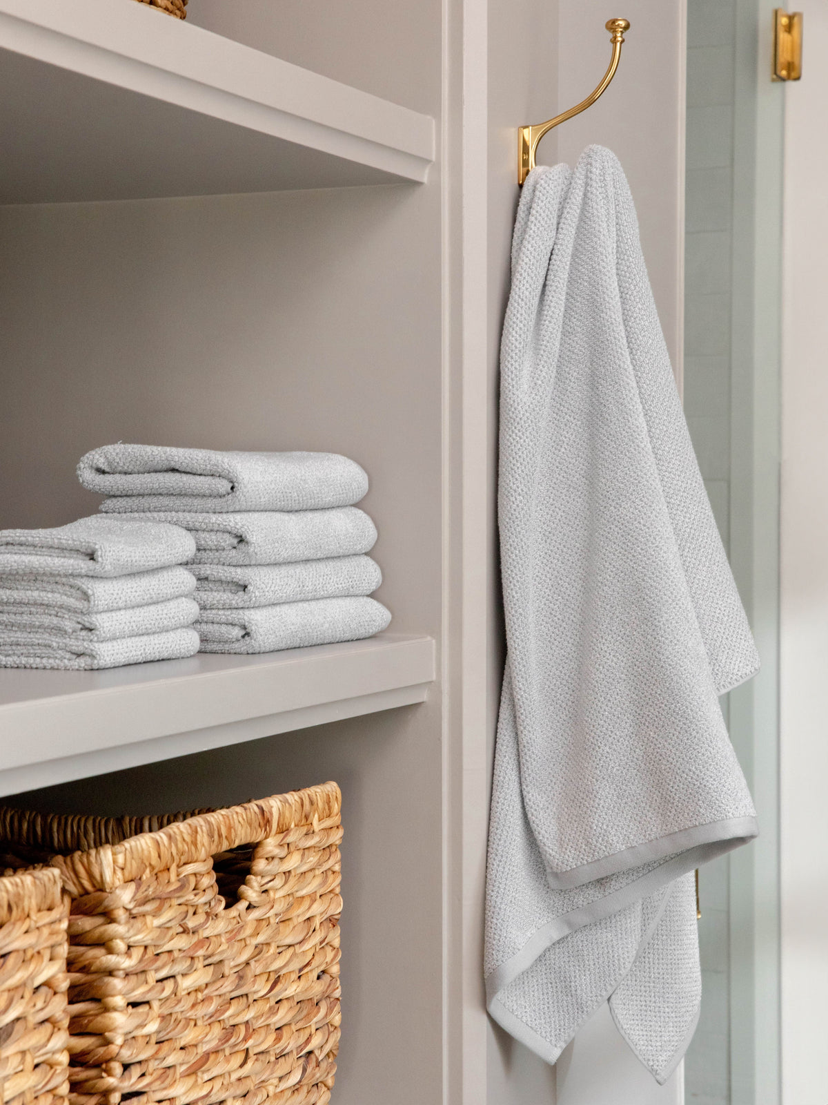 Complete Nantucket Bath Bundle in the color Heathered Harbor Mist. Photo of Complete Nantucket Bath Bundle taken as the hand towels, wash clothes, and bath towels are neatly placed on shelves in a bathroom. |Color:Heathered Harbor Mist