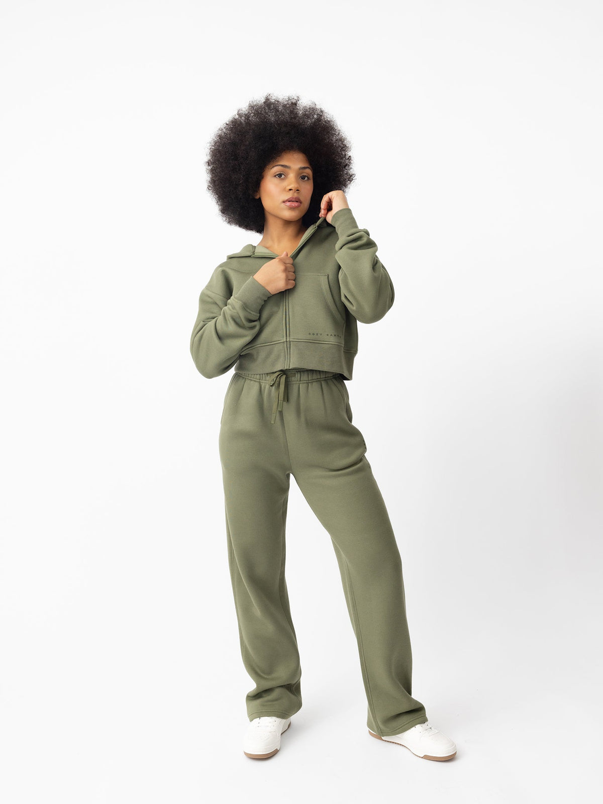 Woman wearing Juniper CityScape Cropped Full Zip with white background |Color: Juniper