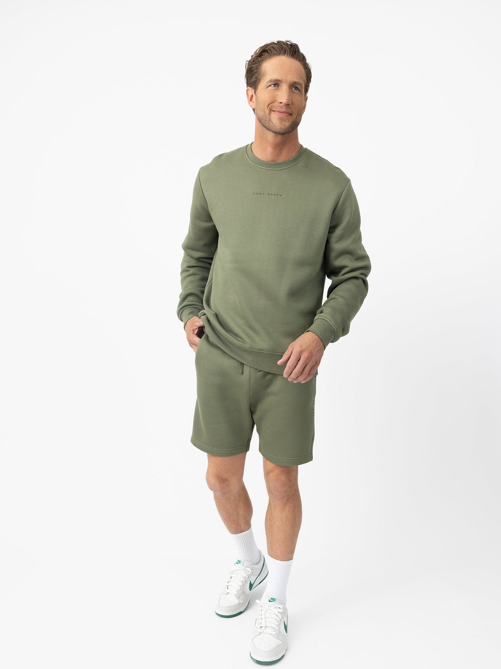 Man wearing Juniper CityScape Shorts with white background |Color: Juniper
