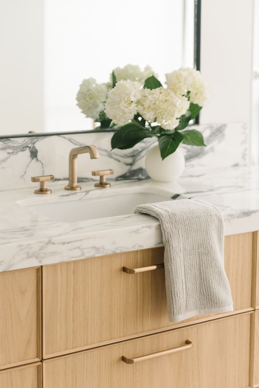Ribbed Terry Hand Towel in the color Light Grey. Photo of Ribbed Terry Hand Towel taken with the Ribbed Terry Hand Towel resting on a bathroom sink. |Color: Light Grey
