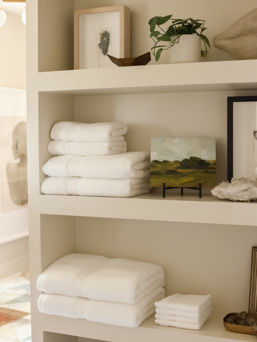 Collection of white luxe towels folded on shelves |Color:White