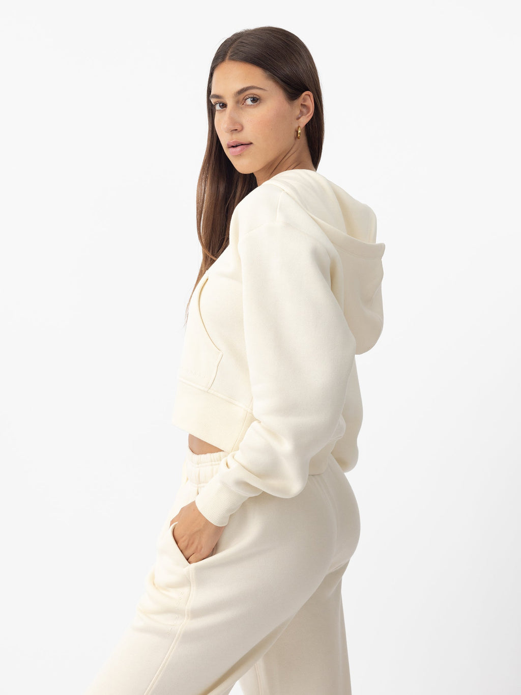 Woman wearing Alabaster CityScape Cropped Full Zip with white background |Color: Alabaster