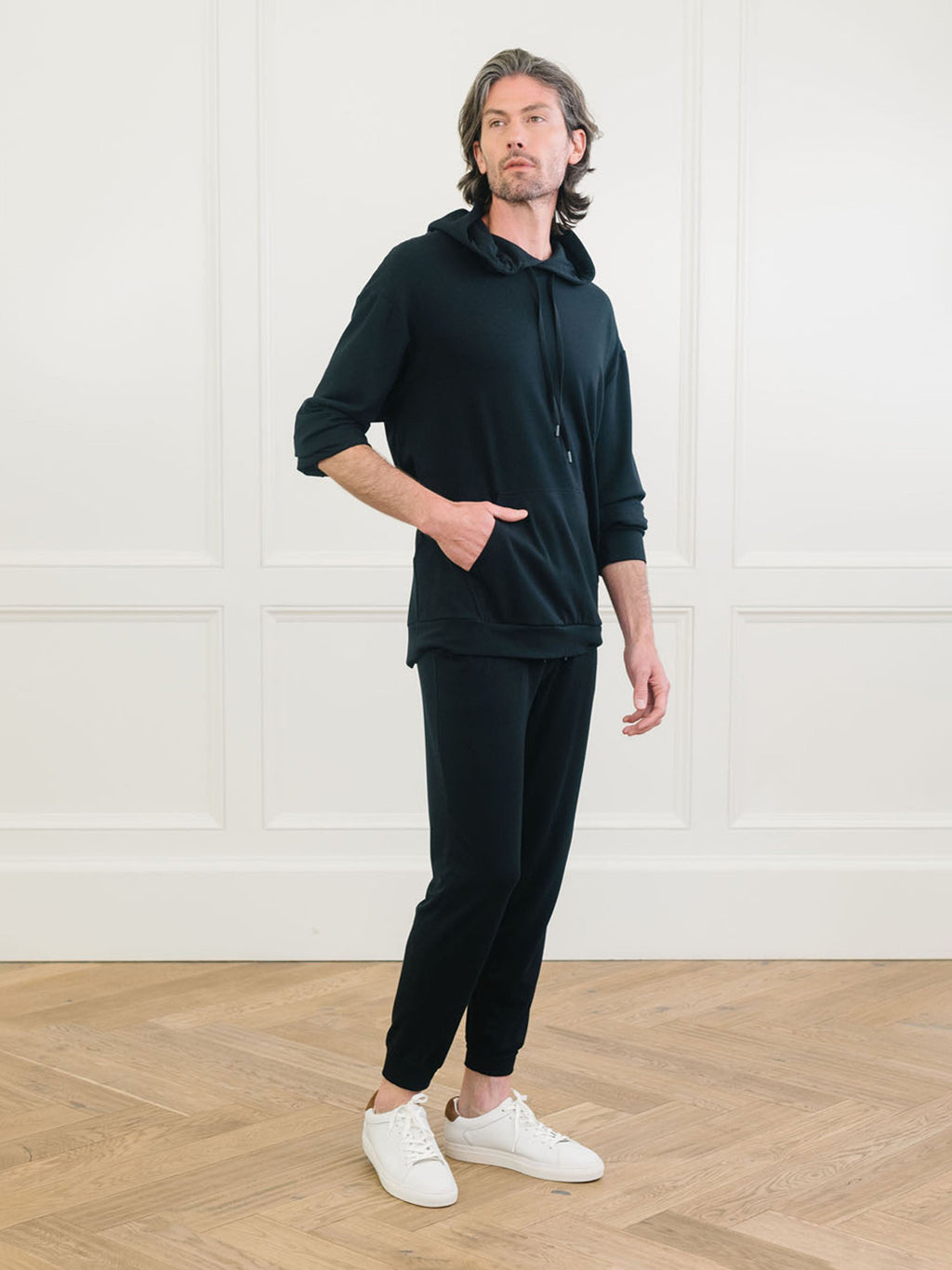 A man wears Men's Brushed Bamboo Hoodie & Jogger Set in Black. |Color:Black