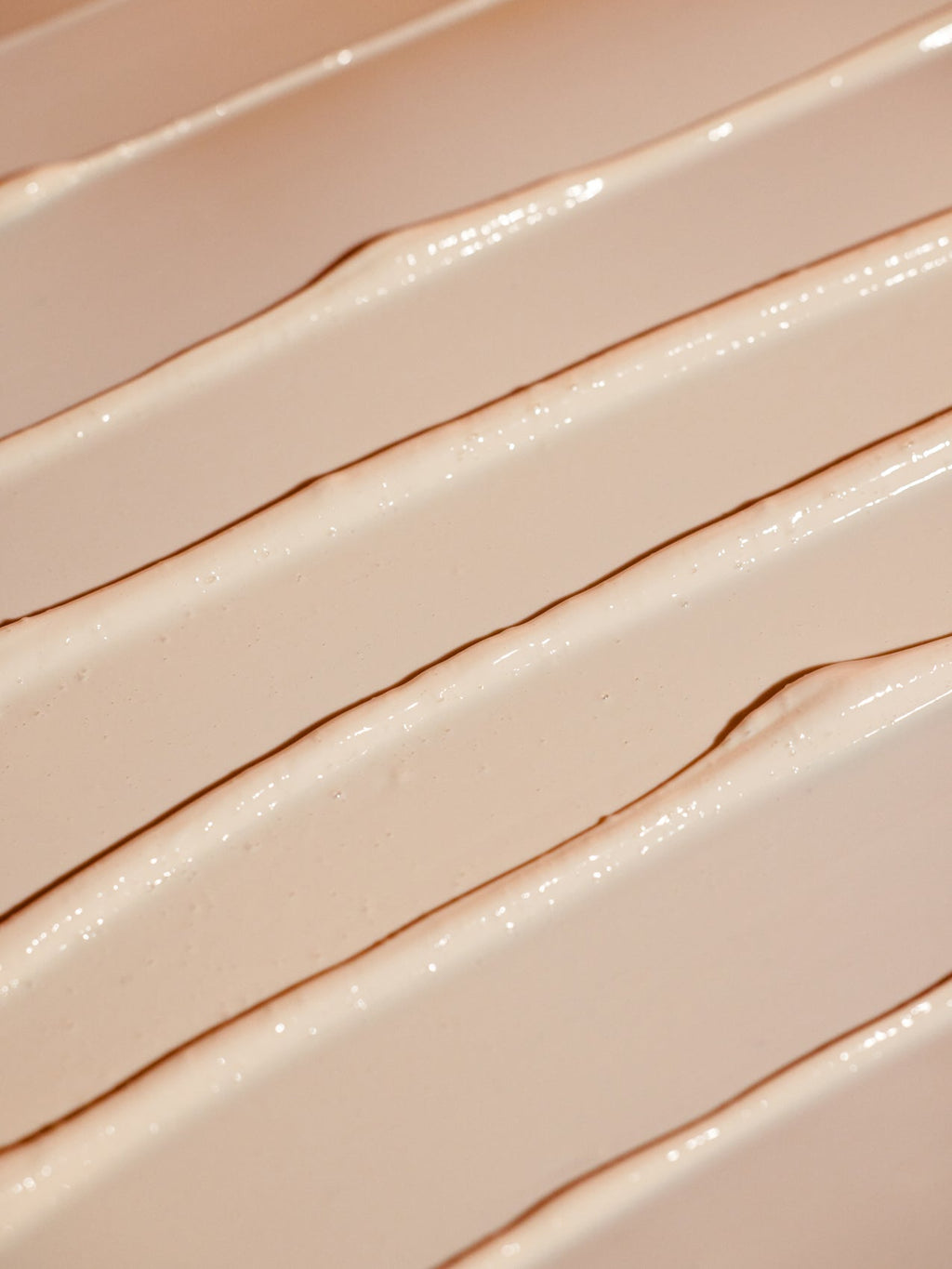 A close-up of the creamy, smooth lines of Cozy Earth's Clay Mask showcases a textured beige pattern on the surface. The light highlights intricate ridges and valleys, adding depth and richness to its appearance. |Size:Full Size