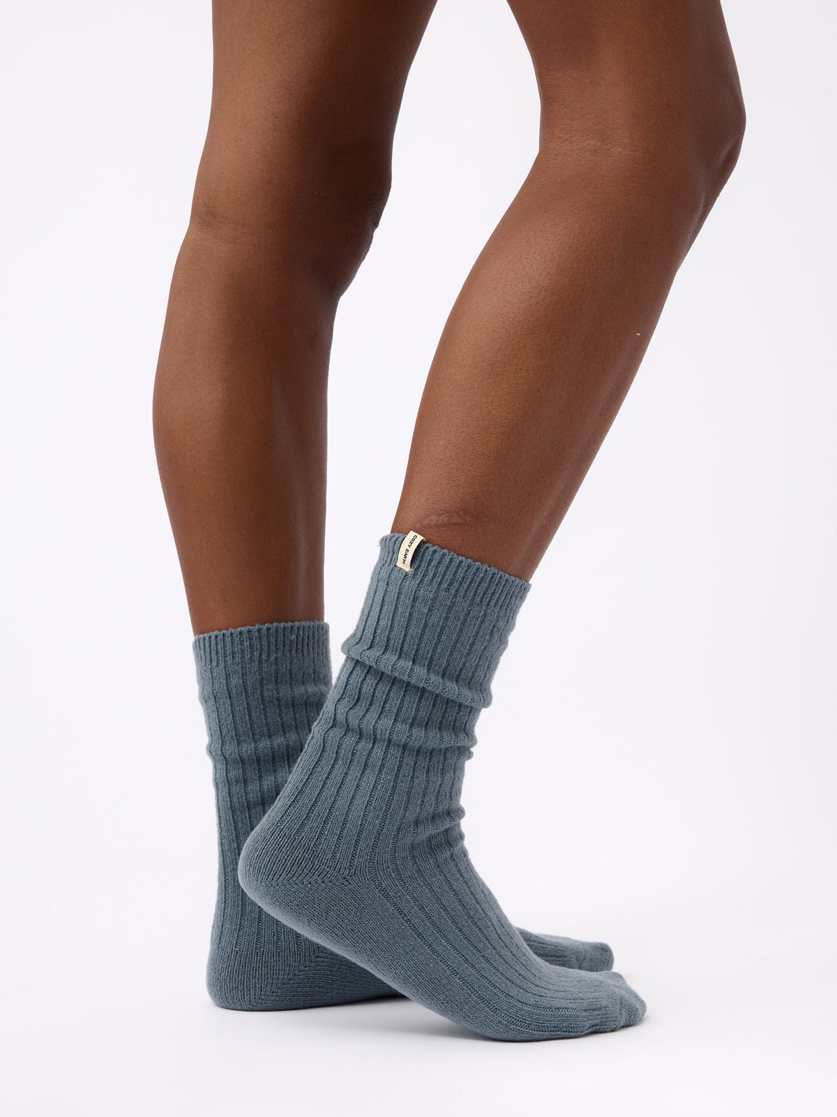 Person turned to the side wearing Cozy Earth Plush Lounge Calf Sock 1-Pack  in Deep Blue |Color:Deep Blue