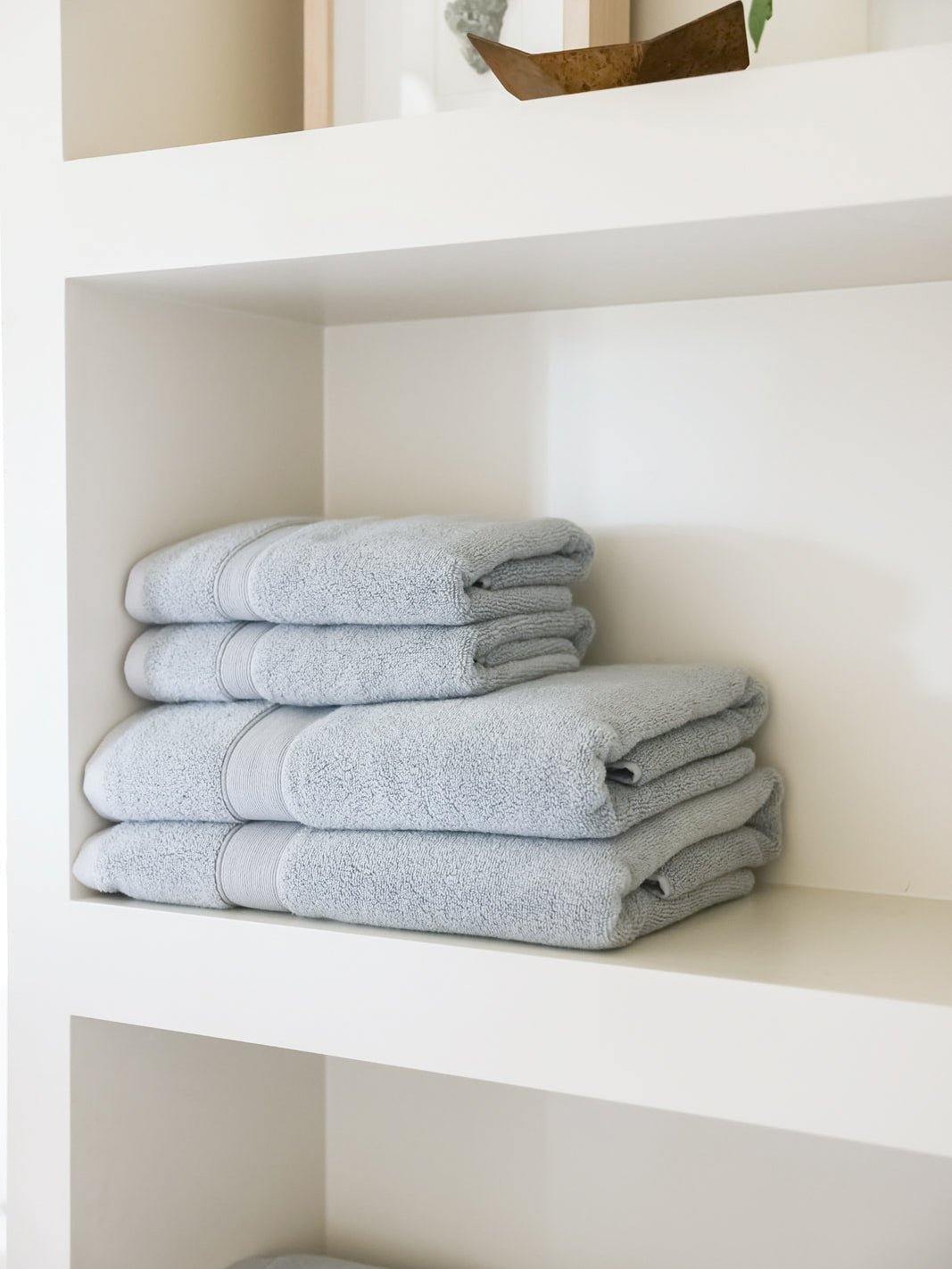 Luxe bath towels and hand towels on shelf |Color:Harbor Mist