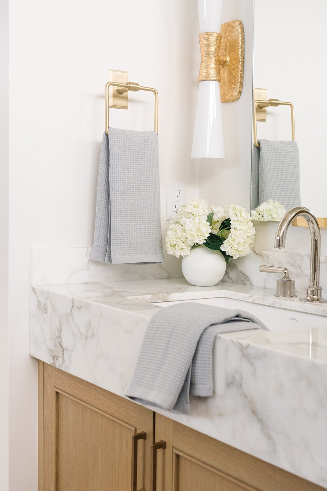 Waffle Hand Towel in the color Harbor Mist. Photo of Harbor Mist Waffle Hand Towel taken with one of the Waffle Hand Towels in Harbor Mist hung from a towel ring. The other Waffle Hand Towel Harbor Mist is resting on a bathroom sink. |Color: Harbor Mist