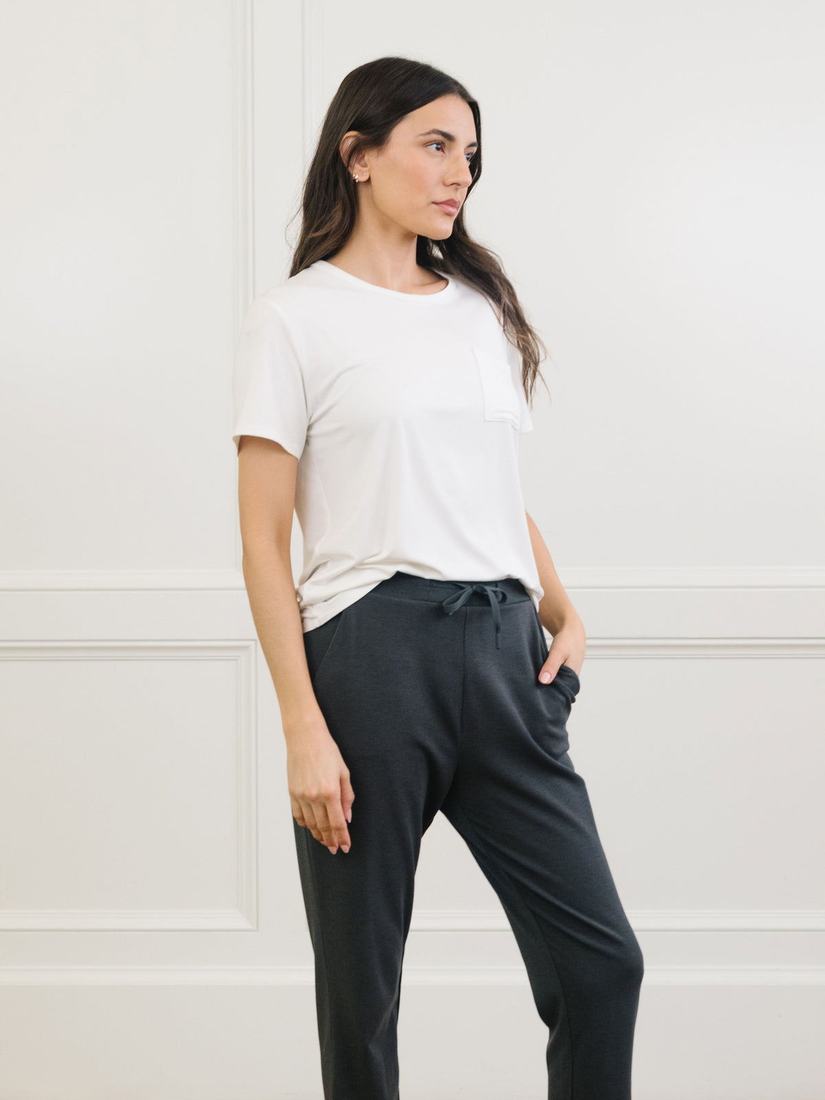 Woman wearing Cozy Earth Bamboo Lounge Tee in ivory faces to the side |Color:Ivory