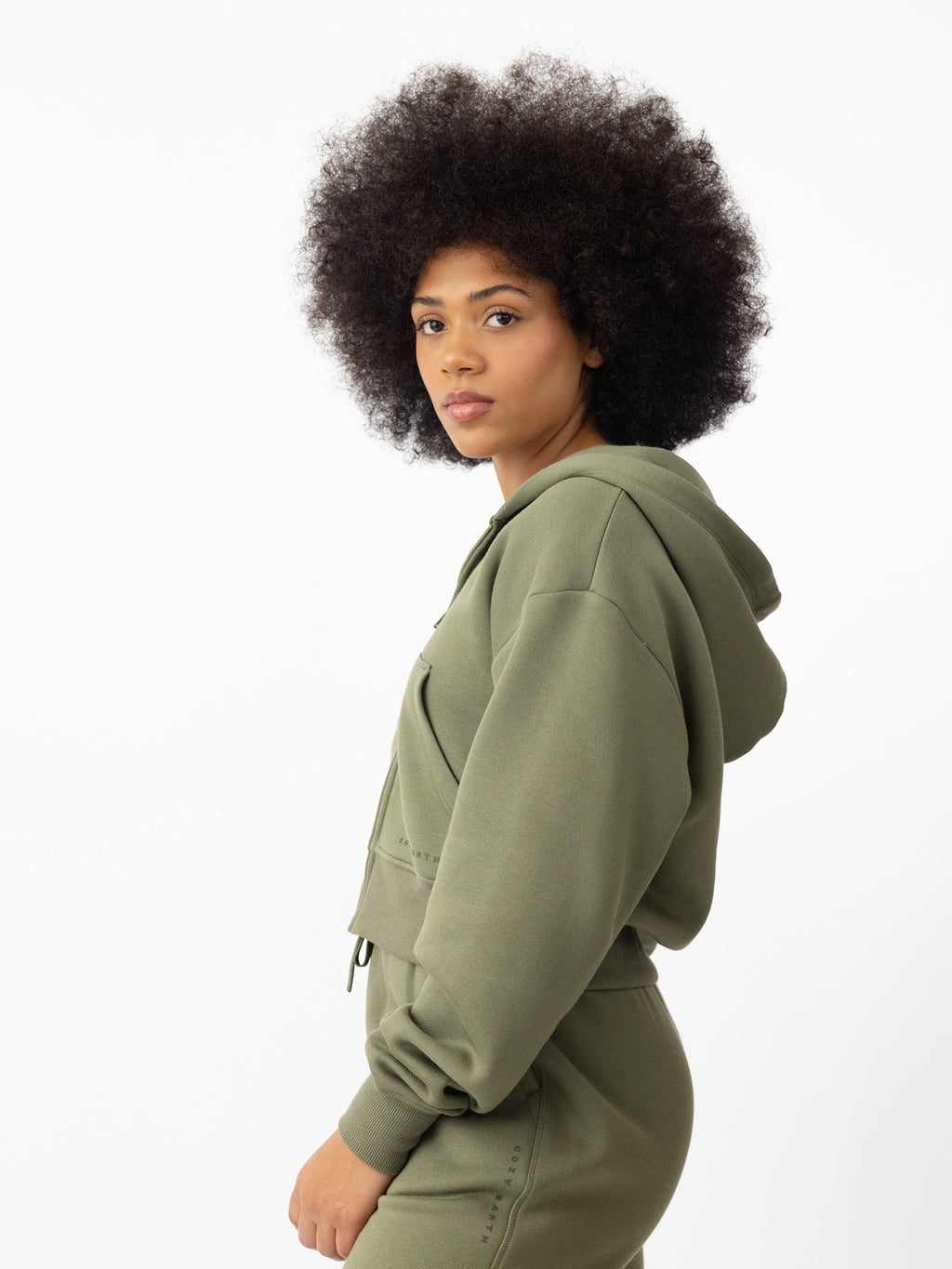 Woman wearing Juniper CityScape Cropped Full Zip with white background |Color: Juniper