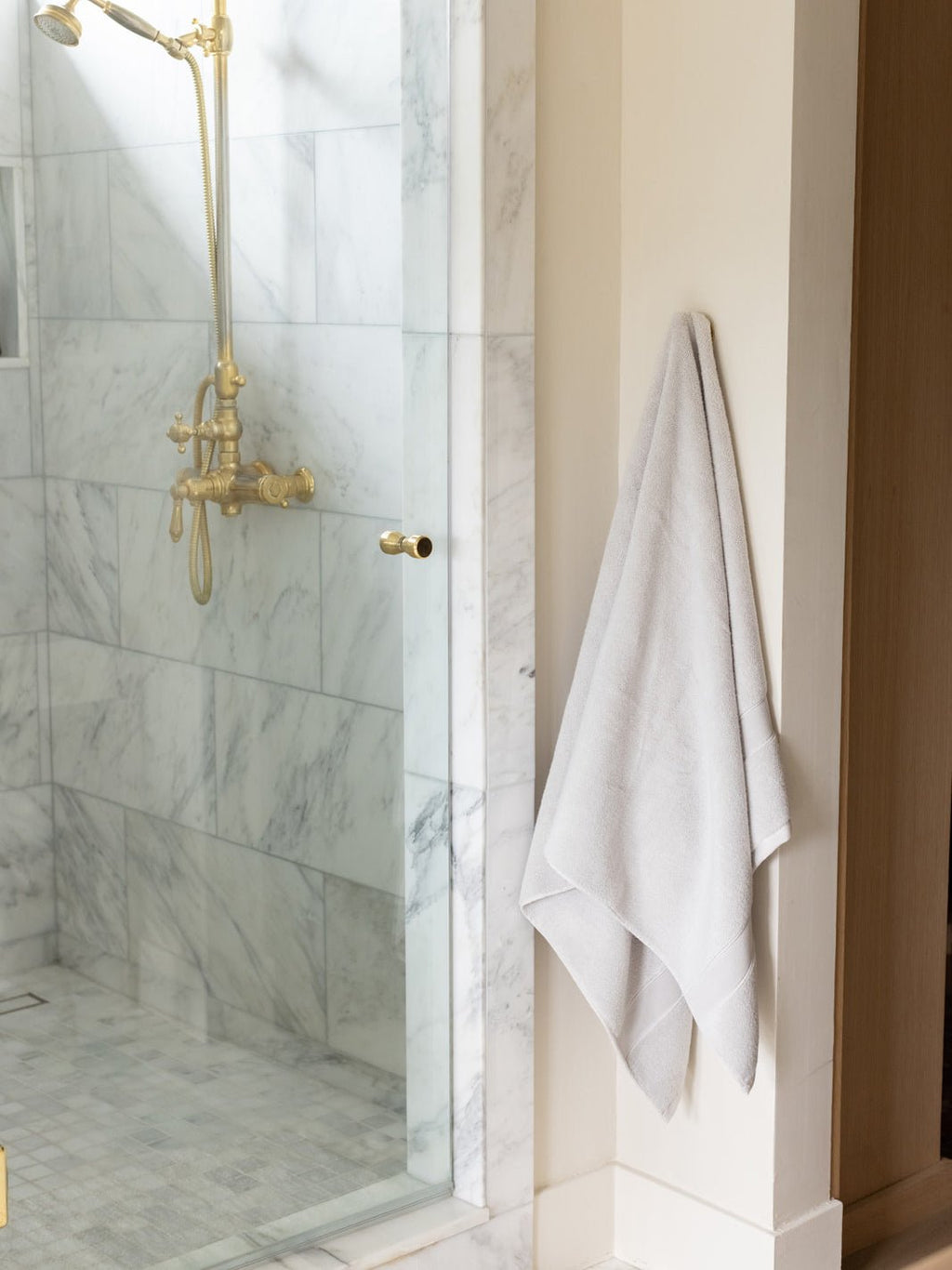 Light grey luxe bath towel hanging next to shower |Color:Light Grey