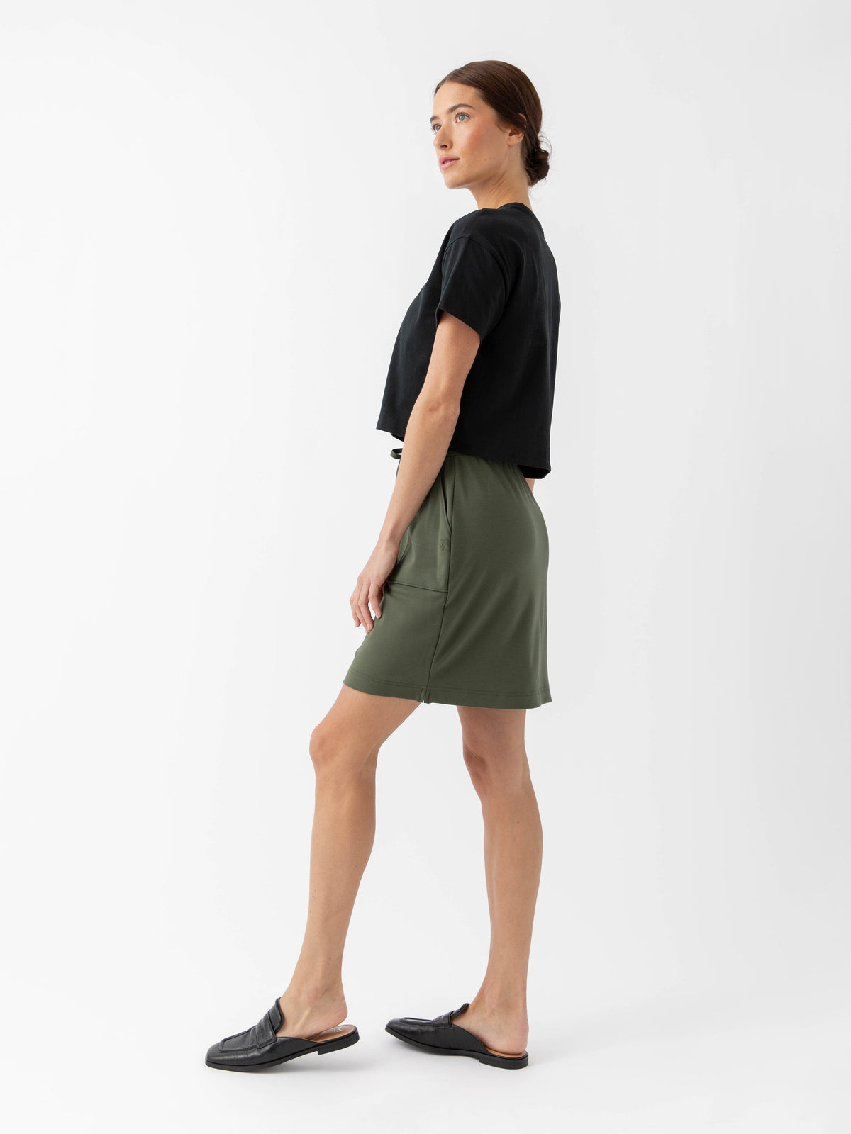 Person wearing a Cozy Earth Brushed Bamboo Patch Pocket Skirt in green on a white background |Color:Olive