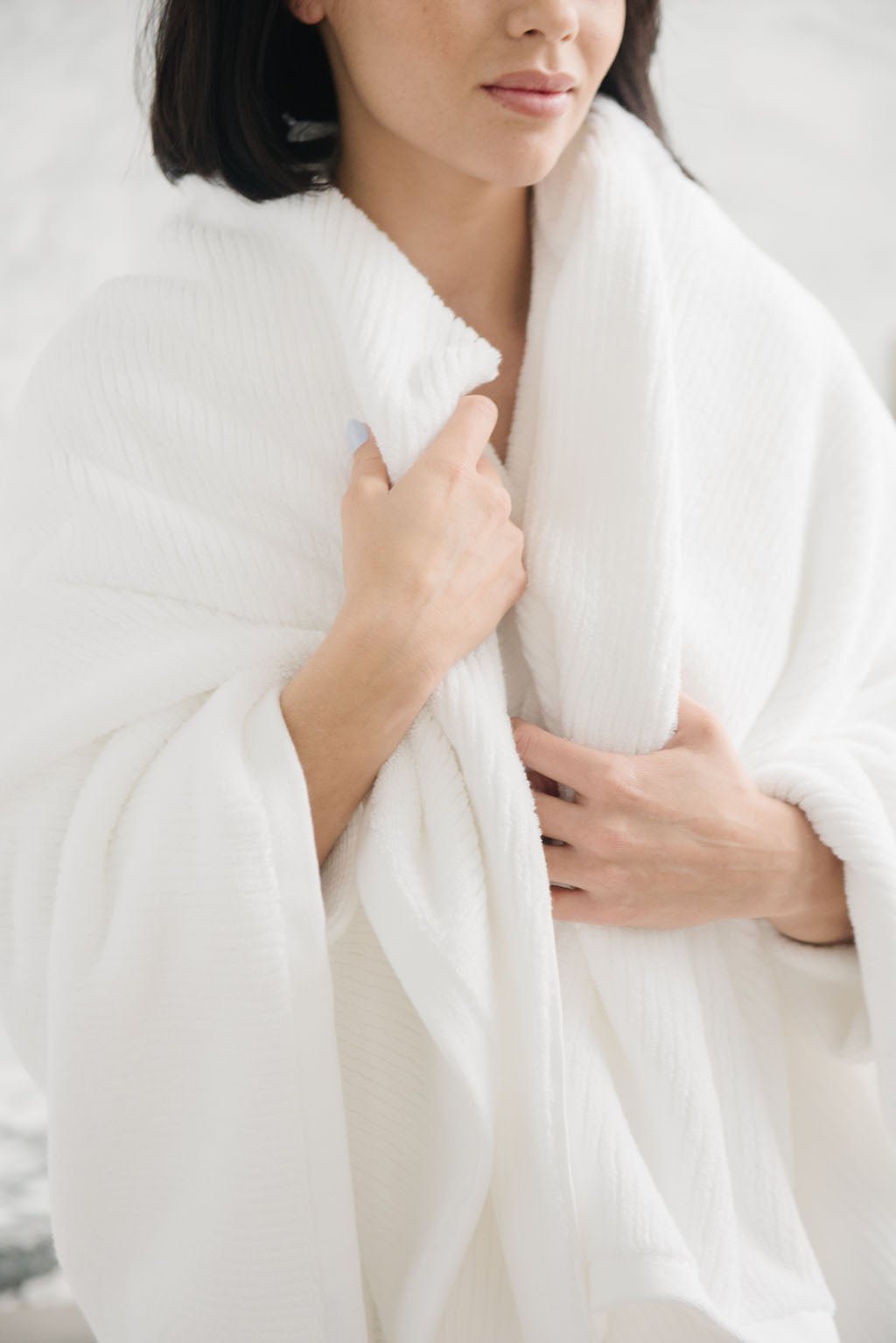 Ribbed Terry Bath Sheet in the color White. Photo of Ribbed Terry Bath Sheet taken with a woman who is wrapped in the Ribbed Terry Bath Sheet. |Color:White
