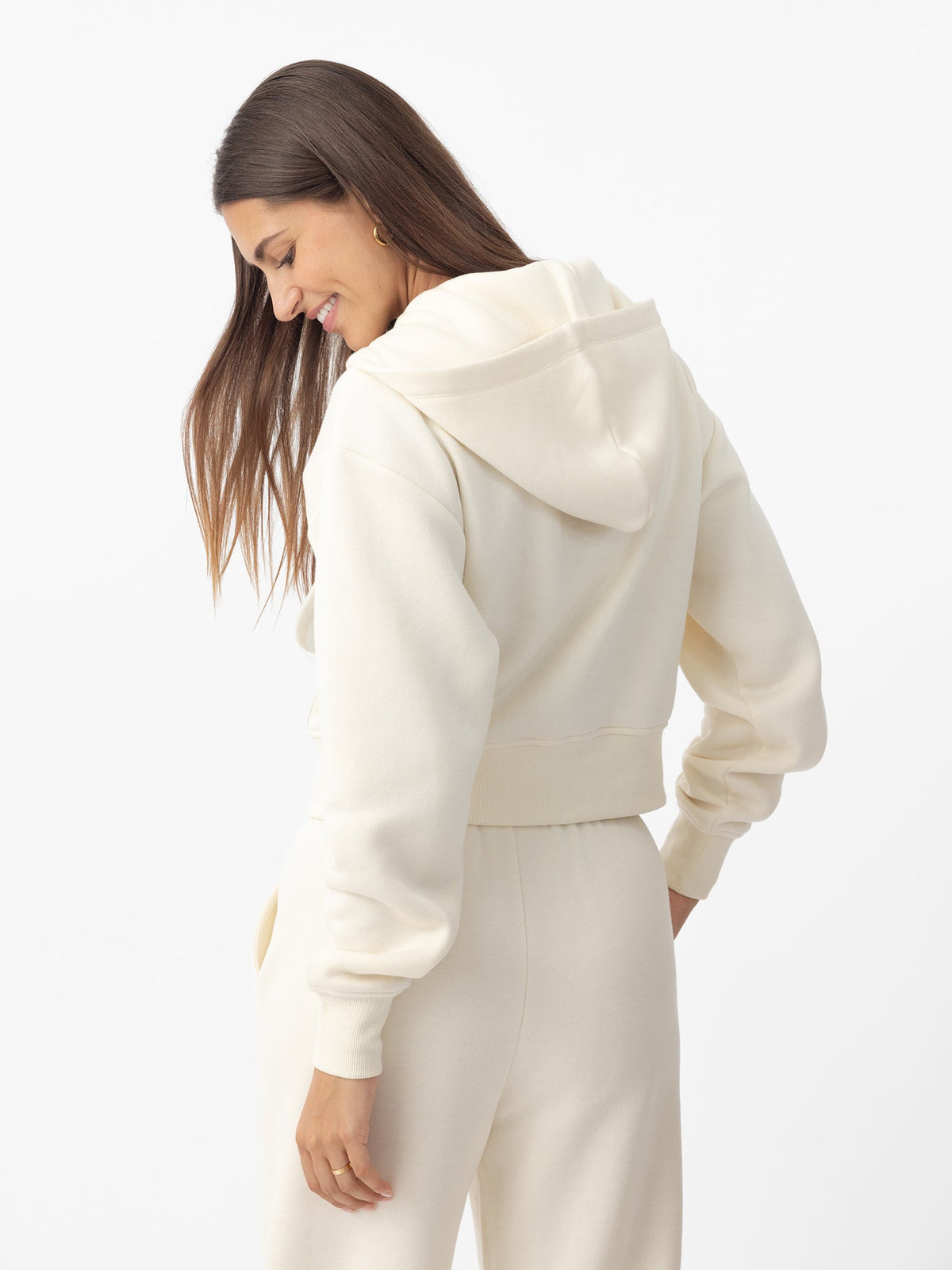 Woman wearing Alabaster CityScape Cropped Full Zip with white background |Color: Alabaster