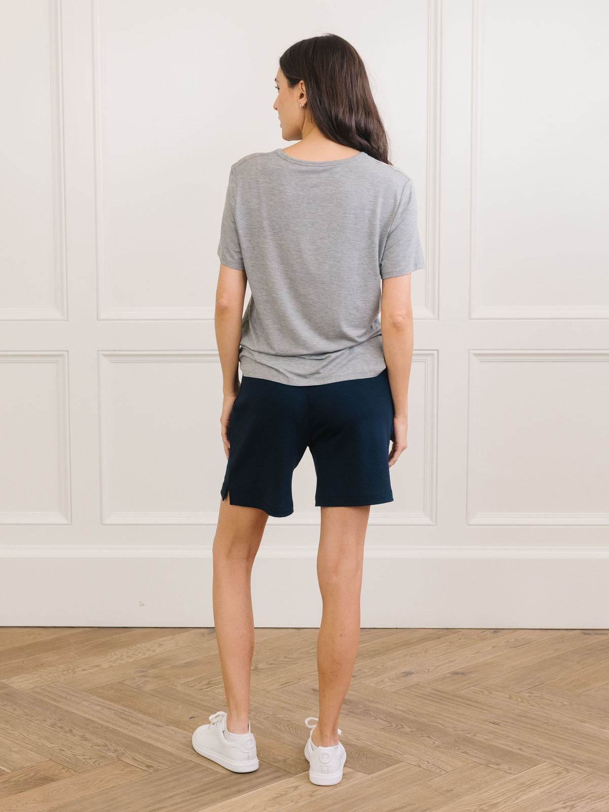 Woman wearing Cozy Earth Bamboo Lounge Tee in grey faces backward |Color:Grey
