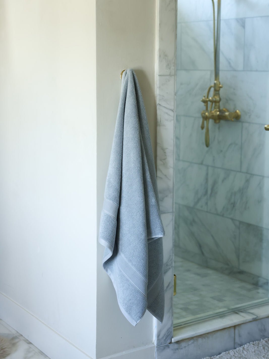 Harbor mist luxe bath towel hanging next to shower |Color:Harbor Mist