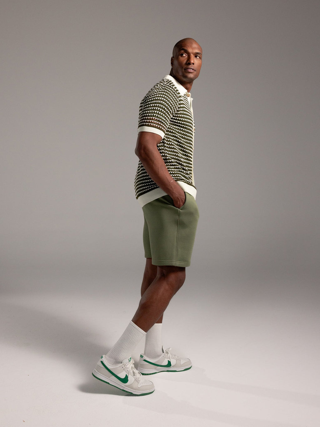 Man wearing Juniper CityScape Shorts with grey background |Color: Juniper