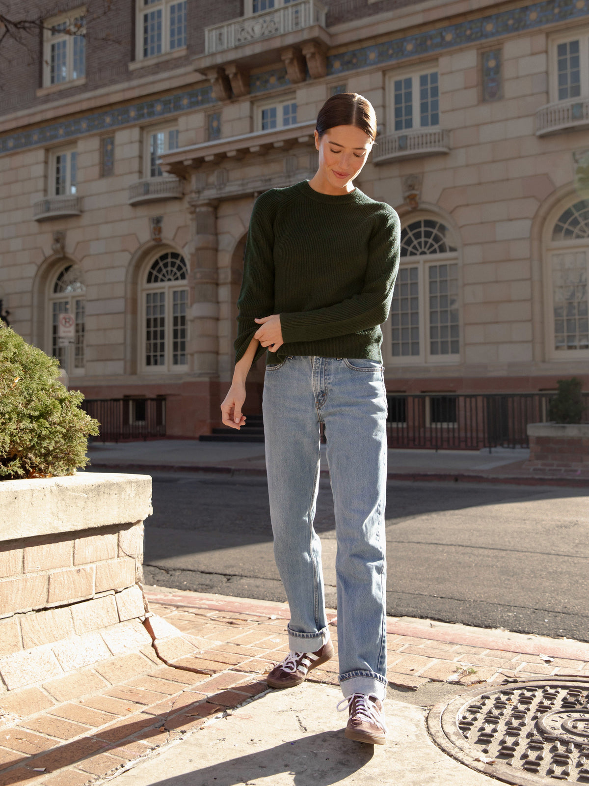 Woman wearing juniper classic crewneck and jeans on city street |Color:Juniper