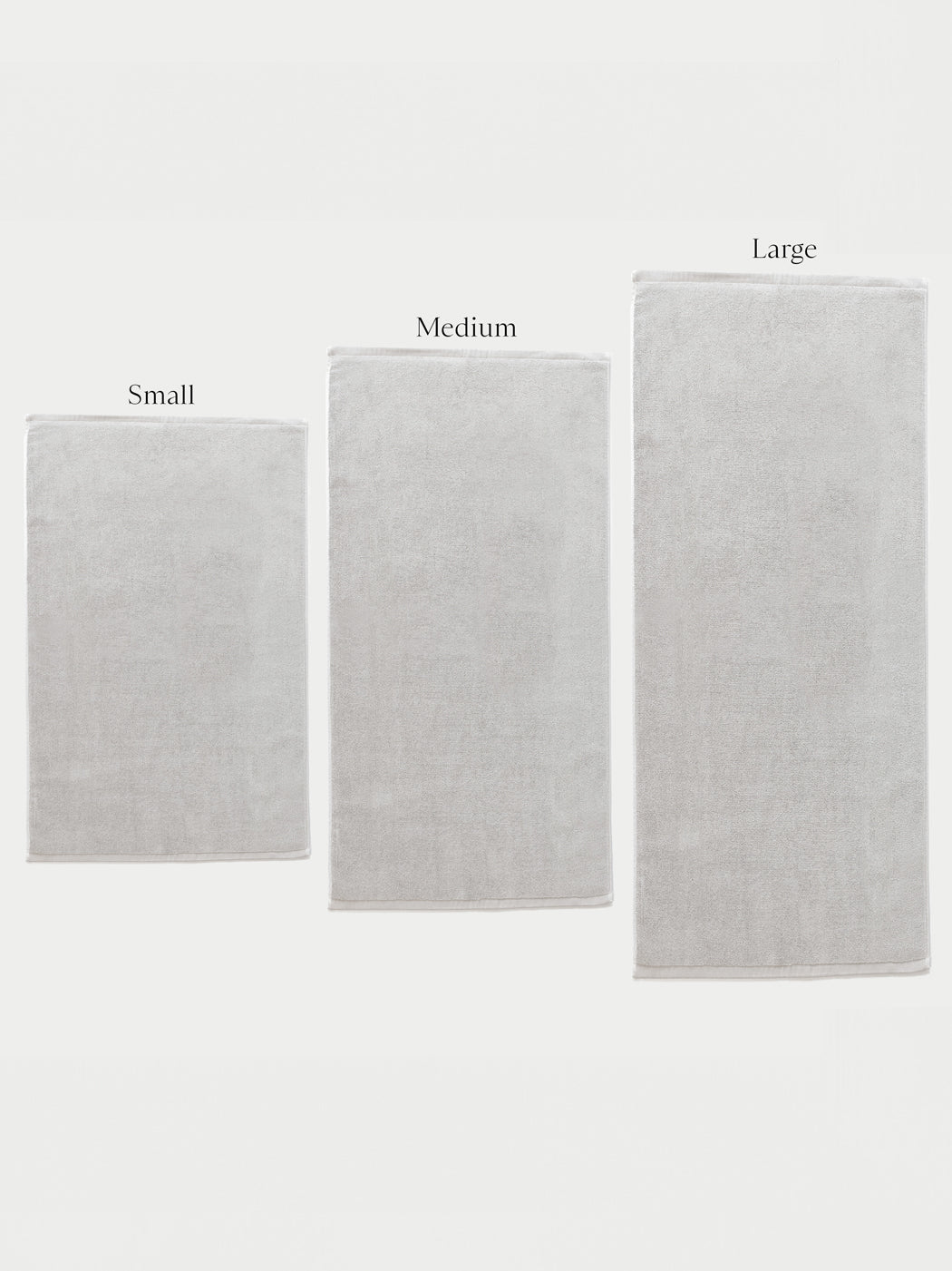 Three Cozy Earth Loop Terry Bath Mats in small, medium, and large are displayed side by side against a white background, each labeled above with its size.|Color:Light Grey