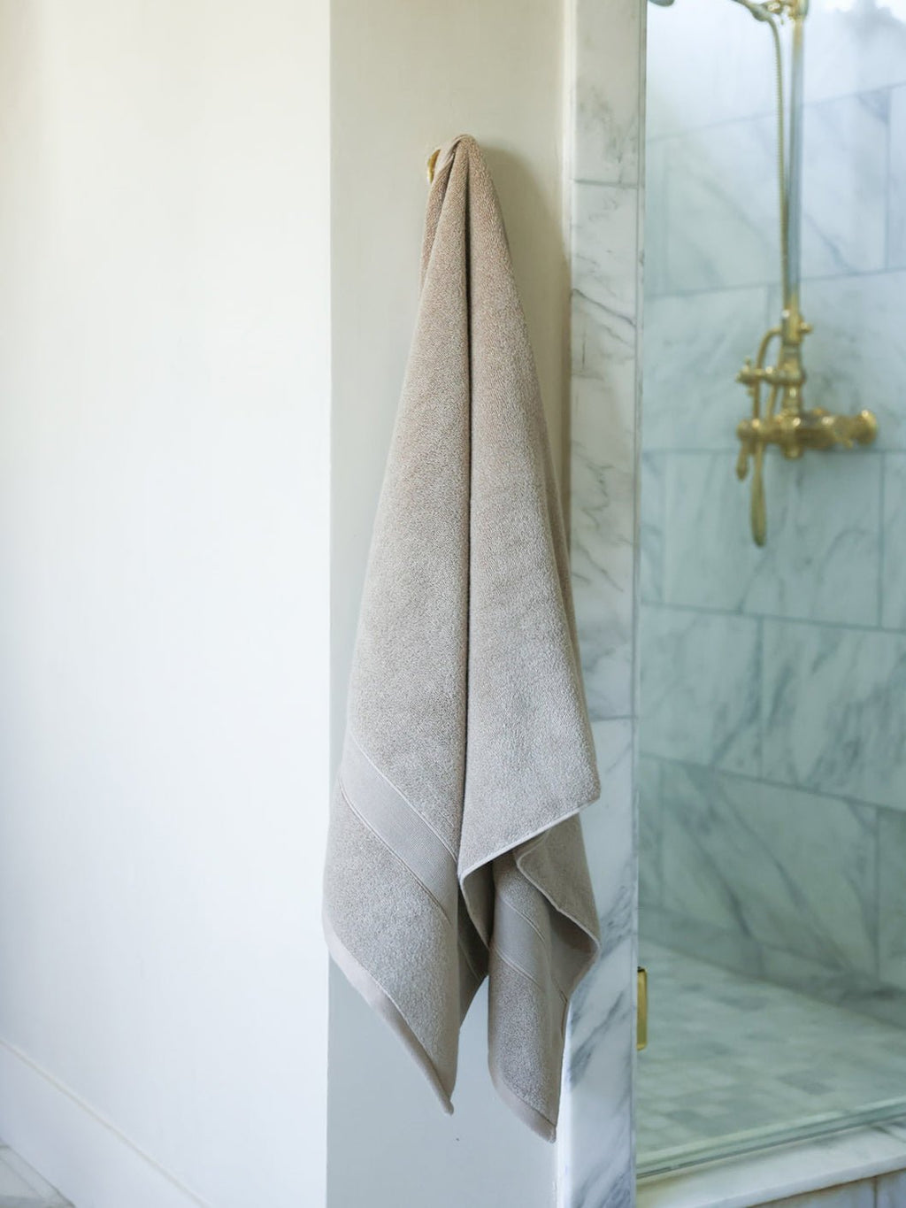 Sand luxe bath sheet hanging next to shower |Color:Sand