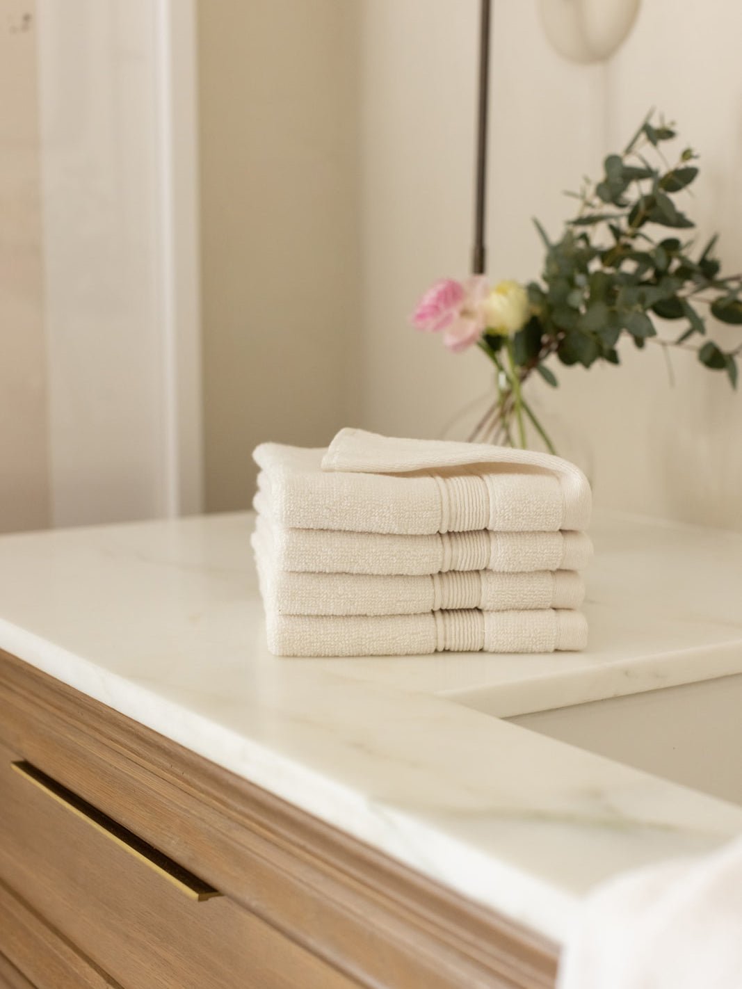 Seashell washcloths folded on bathroom counter |Color:Seashell