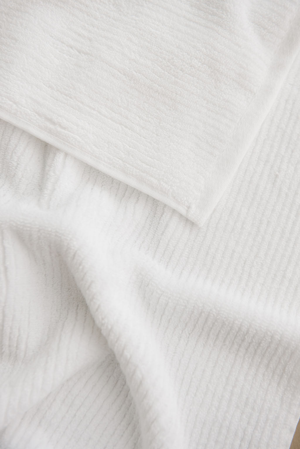 Ribbed Terry Hand Towel in the color White. Photo of Ribbed Terry Hand Towel taken as a close up of the towel. Only the towel is seen. |Color: White