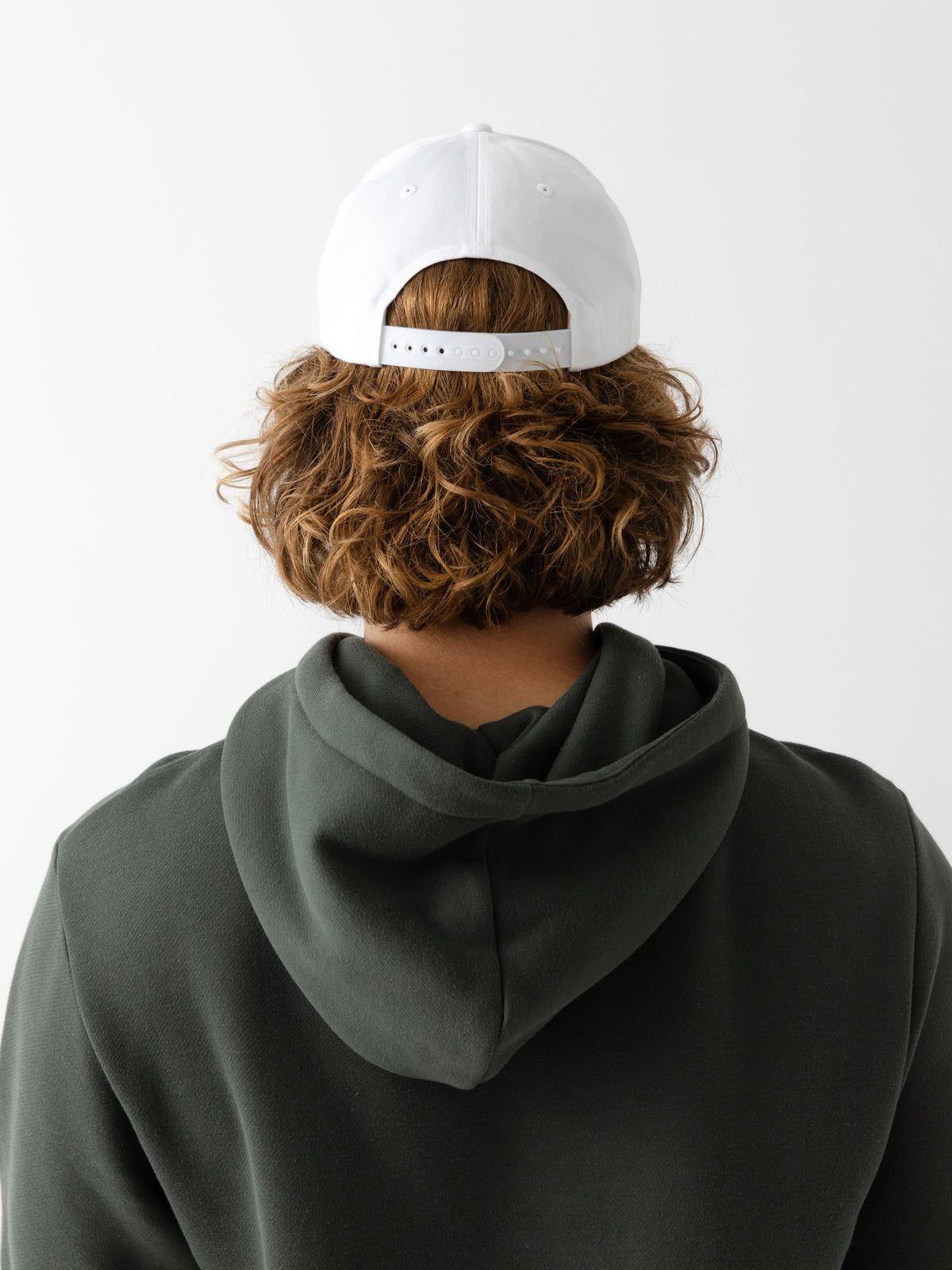 A man facing backwards wearing a White cap on a white background |Color:White/Stone