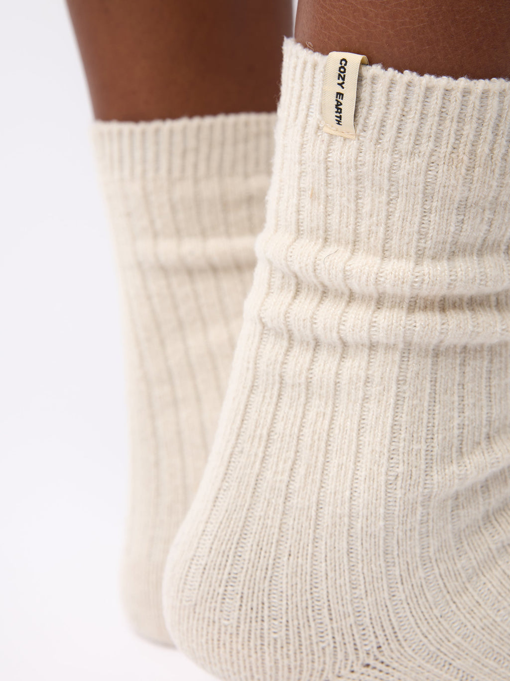 Close-up of the tag on Cozy Earth Plush Lounge Sock 1-Pack in Alabaster |Color:Alabaster