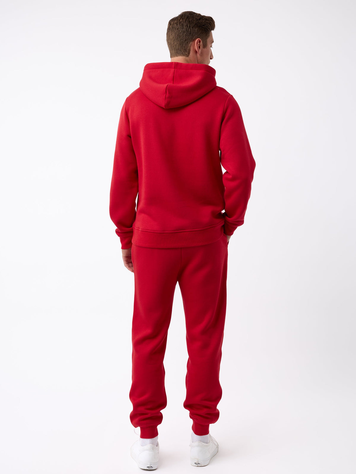A person wearing the Men's CityScape Jogger in red from Cozy Earth stands with their back to the camera against a plain white background, paired with white sneakers. |Color:Crimson