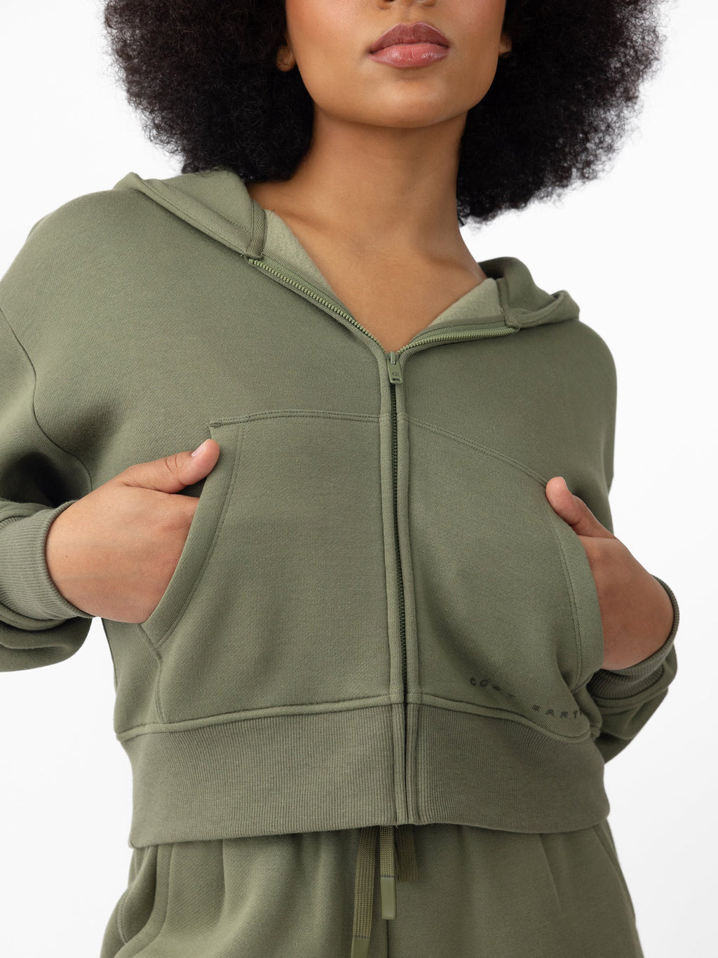 Woman wearing Juniper CityScape Cropped Full Zip with white background |Color: Juniper