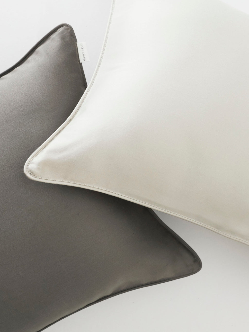 Close up of light grey and charcoal travel pillowcases |Color:Light Grey