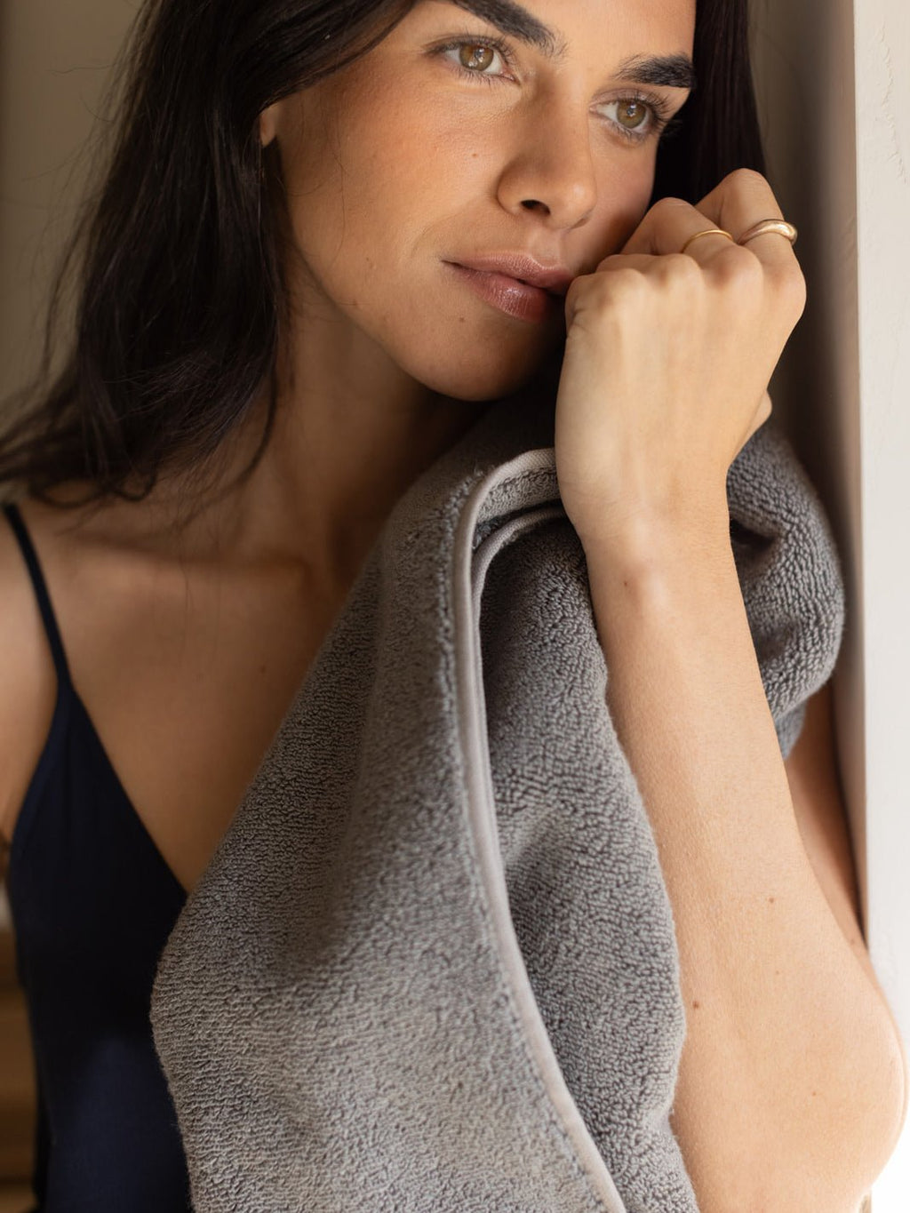 Woman holding charcoal luxe bath sheet |Color:Charcoal