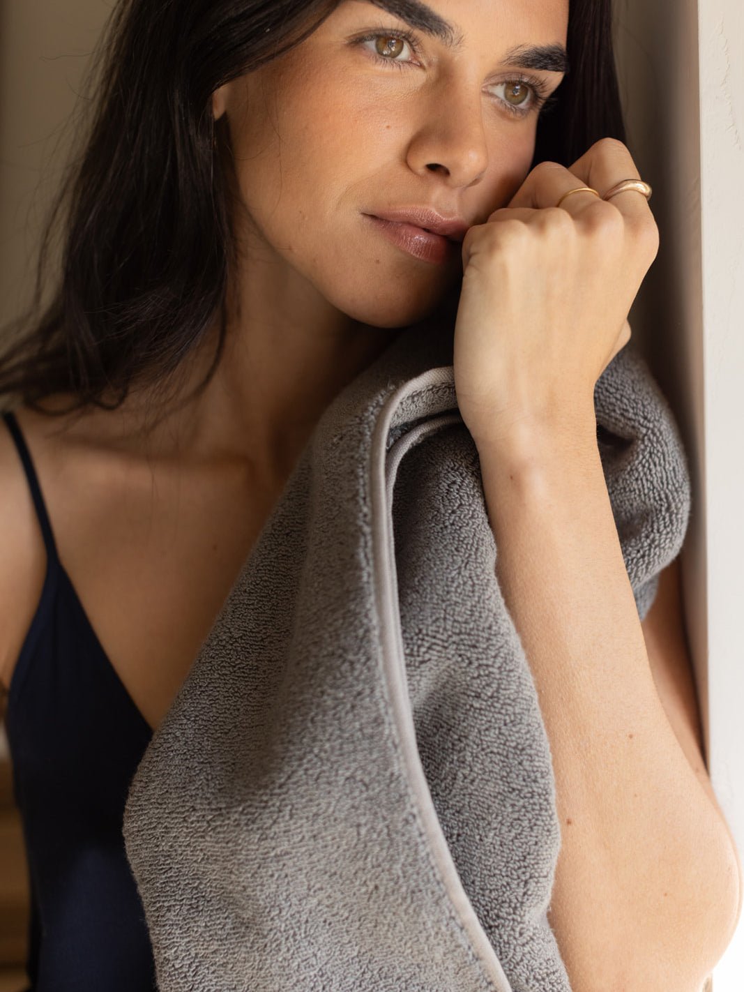 Woman holding charcoal luxe bath sheet |Color:Charcoal