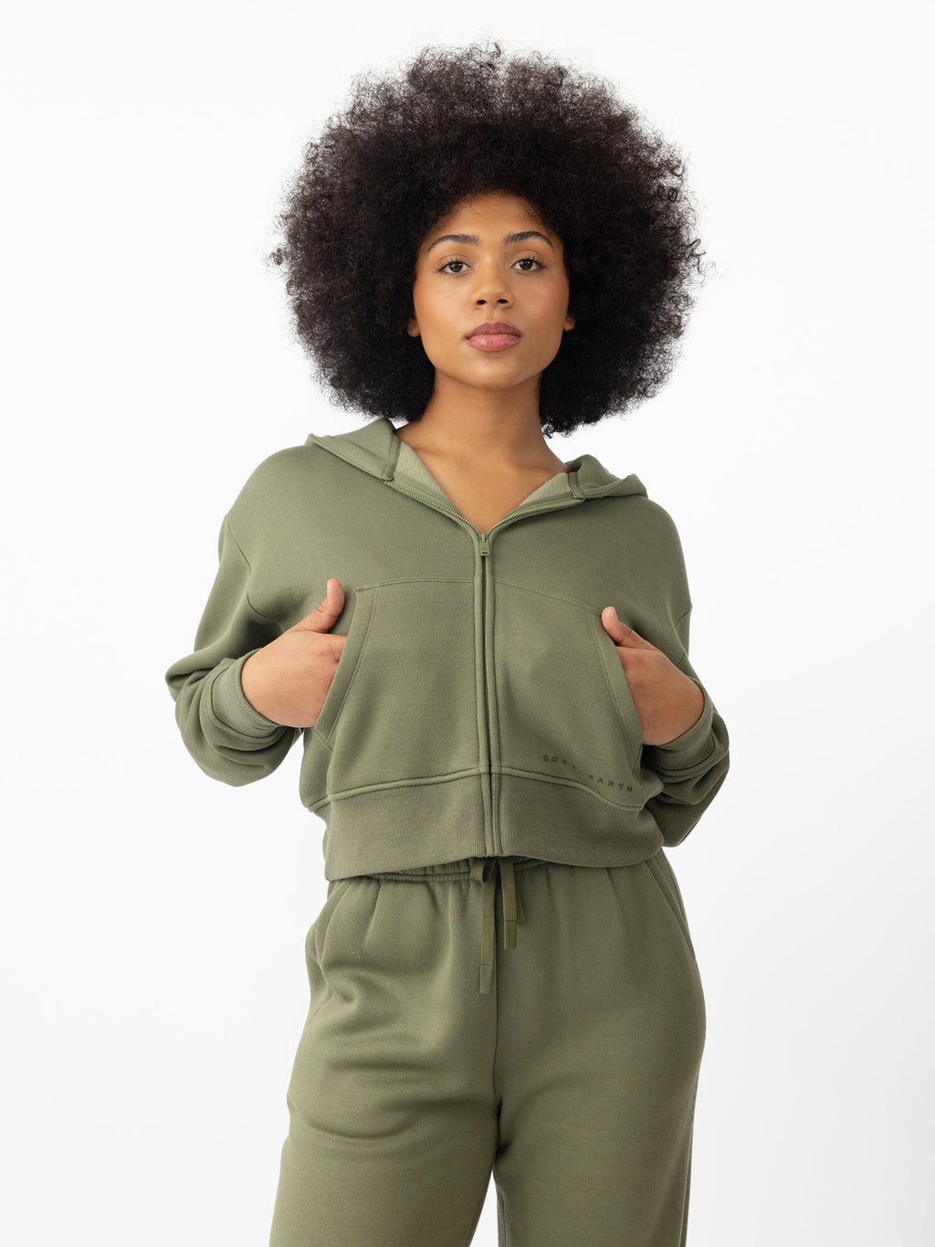 Woman wearing Juniper CityScape Cropped Full Zip with white background |Color: Juniper