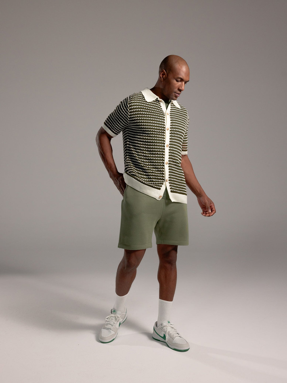 Man wearing Juniper CityScape Shorts with grey background |Color: Juniper