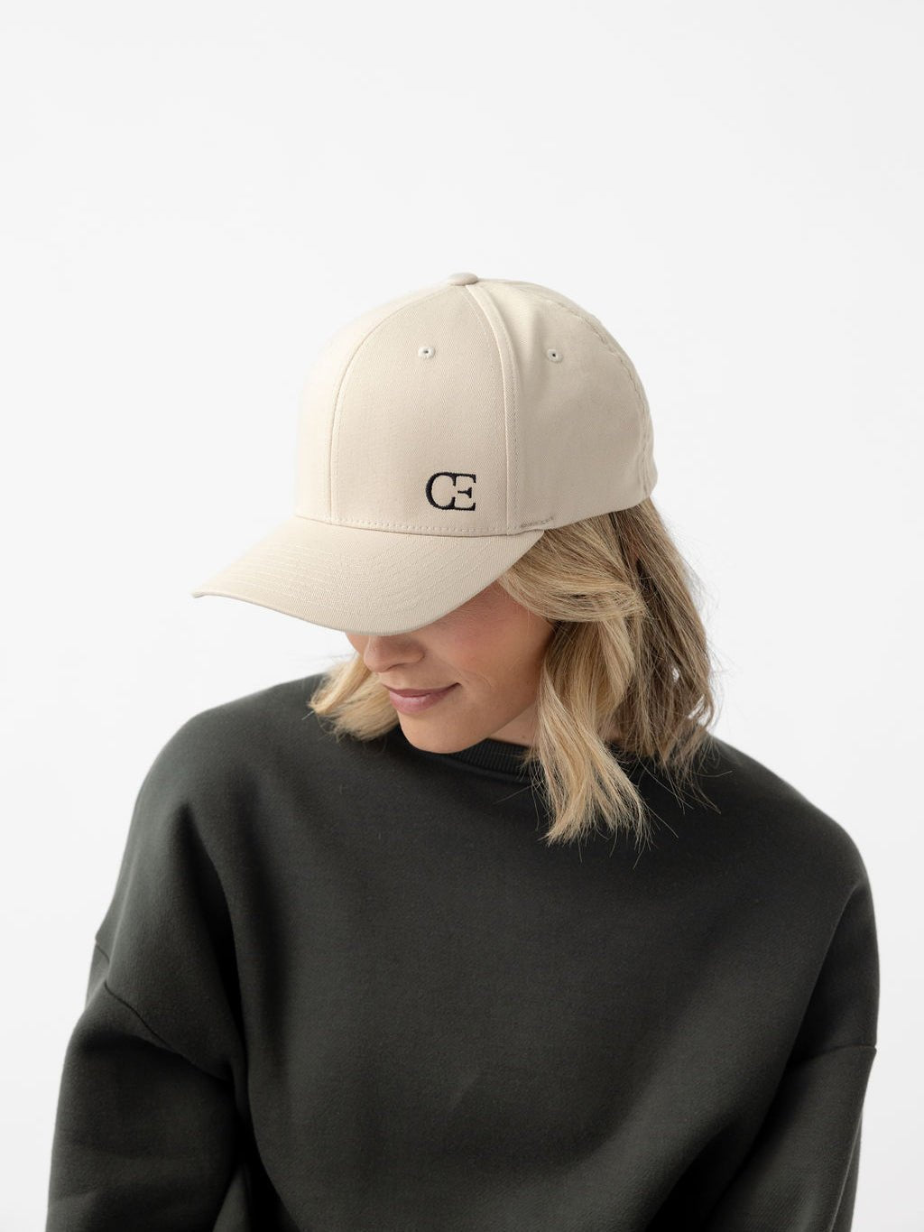 Woman wearing stone urban classic hat looking down |Color:Stone/Black