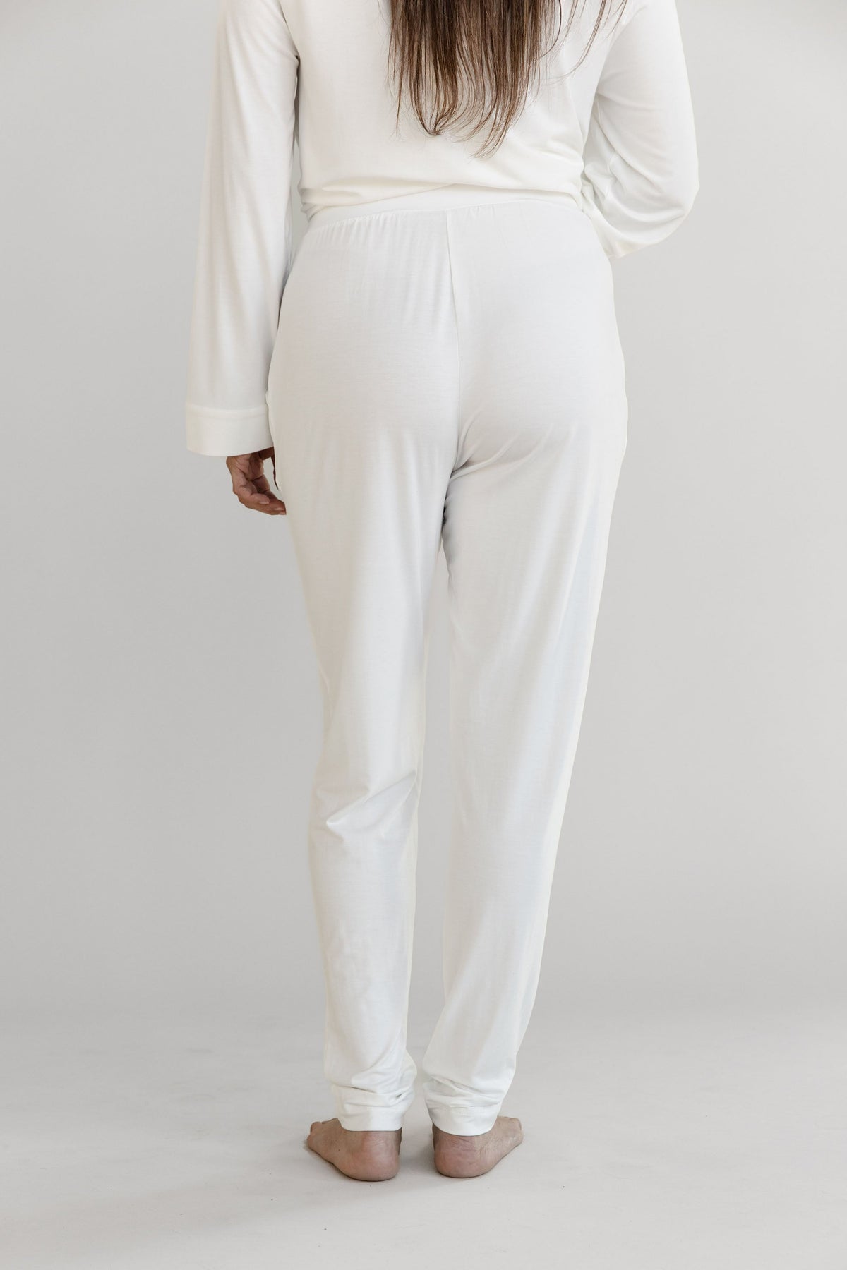 Gray Cozy Earth Stretch Knit Tapered Pant set worn by a person on a light gray background. They face backwards |Color:Ivory