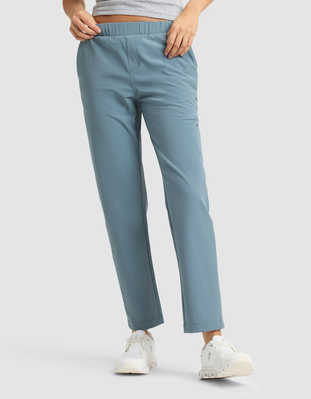 A person wears Cozy Earth's Women's Always Cropped Pant in light blue, paired with a gray top and white sneakers, standing against a plain light background. Only the lower body is shown. |Color:Oceanside