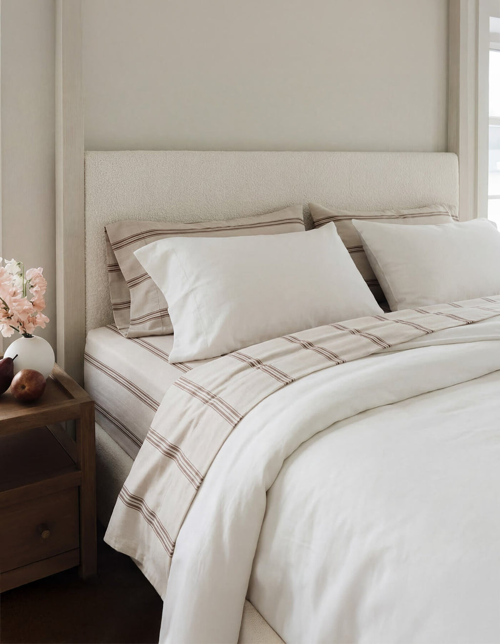 A bed featuring Cozy Earth Bamboo Sheets in Baja Stripe in Maple |Color:Baja Stripe in Maple