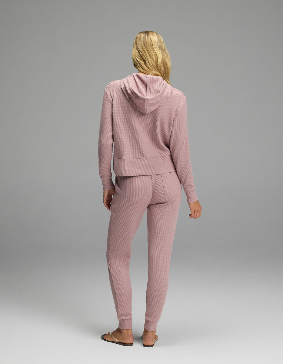 Back view of a person wearing a mauve-colored Women’s Blake Waffle Hoodie & Jogger Set in a textured waffle-knit fabric.|Color:Viola