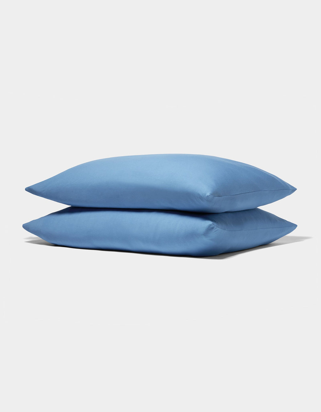 Two neatly stacked Cozy Earth Bamboo Jersey Pillowcases in light blue are displayed on a plain white background.|Color:Sailor