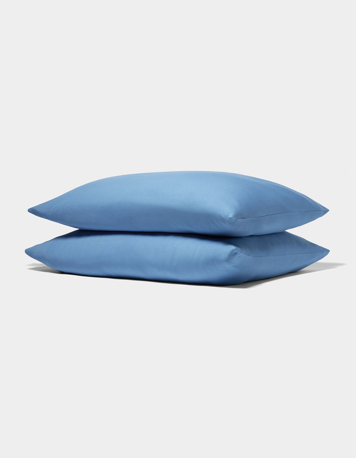 Two neatly stacked Cozy Earth Bamboo Jersey Pillowcases in light blue are displayed on a plain white background.|Color:Sailor