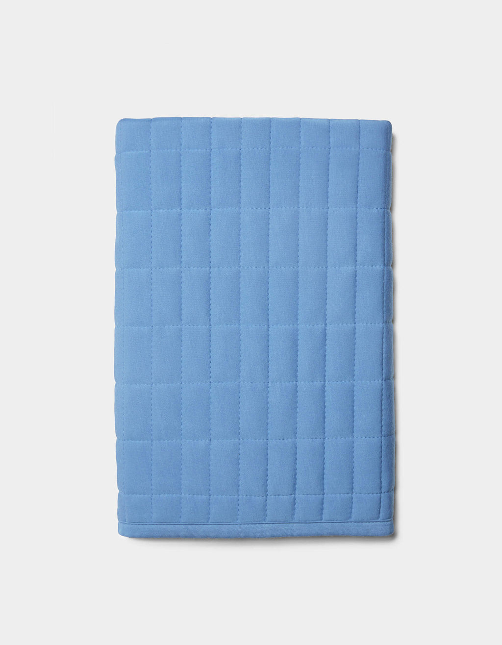 The Cozy Earth Bamboo Jersey Quilted Shams, in light blue with a square quilted pattern, are displayed folded on a plain white background.|Color:Sailor