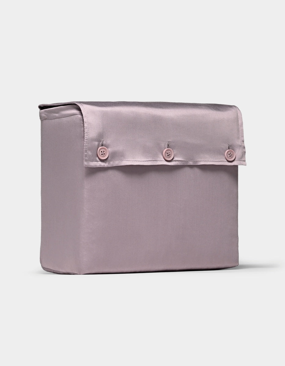 A luxurious, light purple bamboo sheet set from Cozy Earth featuring a smooth satin finish and presented in a rectangular fabric storage box with a flap cover secured by three matching buttons on the front.|Color:Lavender